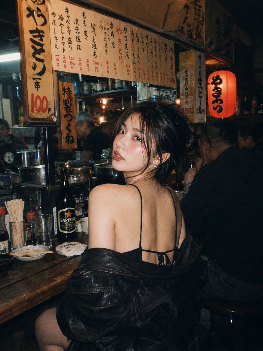 A beautiful young East Asian woman with long dark wavy ha...